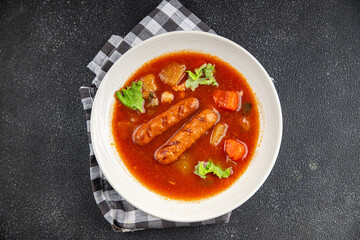 Tomato soup with sausages fresh tasty food dish delicious gourmet food background on the table rustic food top view copy space