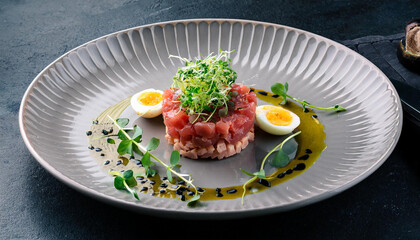 snack tuna tartare with raw quail eggs sauce and microgreens