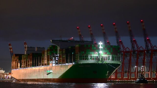 HAMBURG, GERMANY - Jan 31st, 2025: 4k - Ever Aeon is entering the Hamburg Harbor in the night