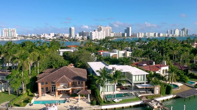 MIAMI, UNITED STATES - FEBRUARY 8, 2025: Aerial view of luxury waterfront homes in Miami showcasing modern architecture and palm trees