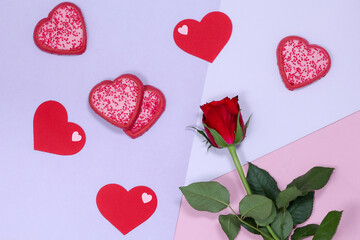 Valentine's Day. Heart-shaped cookies and a red rose.