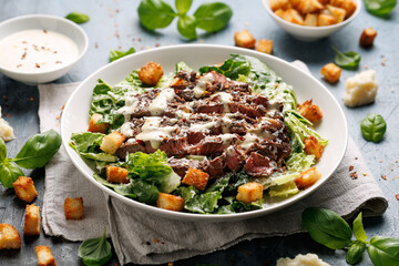 Beef steak Caesar salad with croutons, parmesan cheese and lettuce. Healthy food