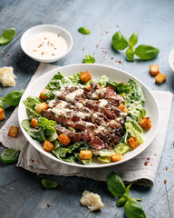 Beef steak Caesar salad with croutons, parmesan cheese and lettuce. Healthy food