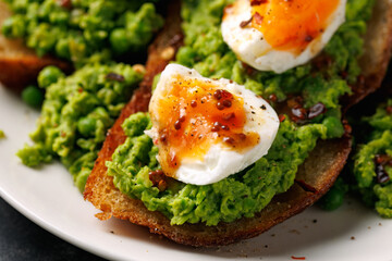 Smashed peas and egg sourdough toast with whole grain mustard sauce. Protein packed vegetarian food concept