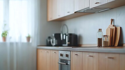 Fototapeta premium Modern Kitchen Interior With Light Wood Cabinets And Natural Lighting