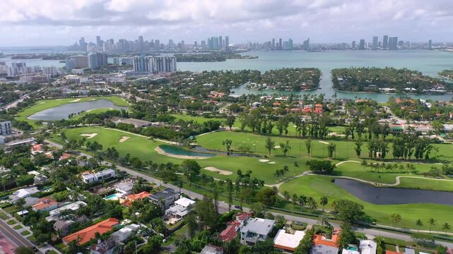 MIAMI, UNITED STATES - FEBRUARY 8, 2025: Aerial view of Miami skyline with lush green golf courses and waterfront properties