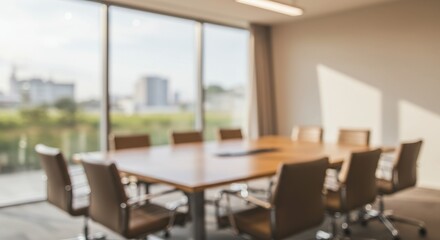 A blurred image of a bright conference room with a wooden table and chairs