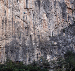 climbing a high vertical rock 