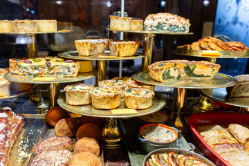 Fresh, varied dishes in the window of a grocery store, restaurant.