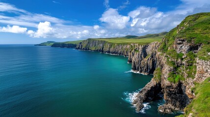 Fototapeta premium Scenic coastal cliffs with blue ocean and clear sky
