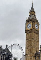 The Big Ben tower standing majesticly infront of the London Eye. Londons most iconic attractions combined in one picture.