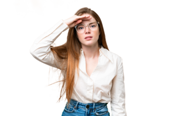 Young pretty woman over isolated chroma key background looking far away with hand to look something