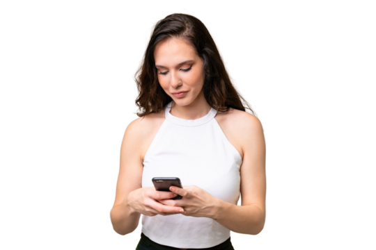 Young caucasian woman isolated over isolated background sending a message with the mobile