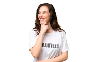 Young volunteer caucasian woman over isolated background looking to the side and smiling