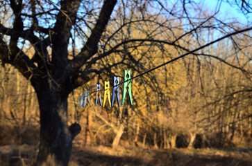 Clothespins hang on a wire
