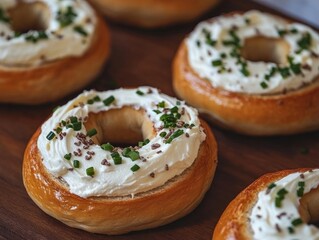 cream cheese slathered on freshly baked bagels with chives sprinkled on top