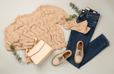Flat lay with women's trendy spring outfit on gray background,, top view