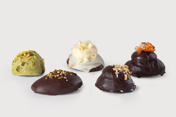 a collection of five different Neapolitan ramas, one with creamy pistachio, one with smooth white chocolate, and three with rich, decadent chocolate, on a white background