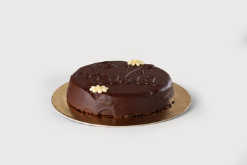 delicate Torta Savoia, a traditional Italian cake with layers of soft sponge, rich chocolate cream, and a glossy finish, offering a luxurious and decadent treat, set against a simple white background