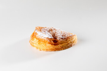 A delicate, flaky pastry filled with smooth ricotta cheese, capturing the simplicity and richness of this classic Sicilian or italian treat in a close-up shot.