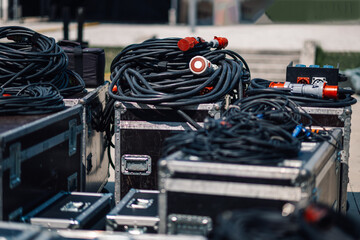 Audio cables lying on storage cases outdoors