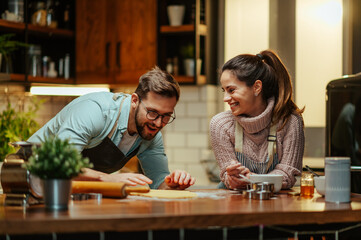Young couple cooking together in modern kitchen at home