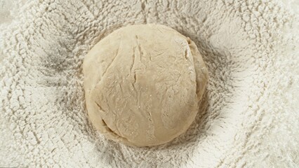 Freeze motion of falling yeast dough into heap of flour.