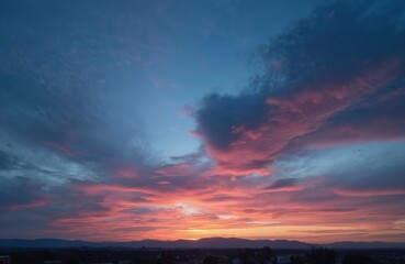 Fototapeta premium Mediterranean winter sky after sunset. Evening cloudscape, mountain range, nature dawn. Skyline orange sunlight, sea coast landscape. Solar cloudscape scenic background. Pink, blue, golden heaven