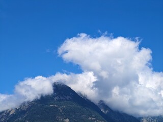 The clouds look like a giant climbing a mountain, Martigny, Switzerland