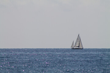Fototapeta premium Solitary Sailboat on a Calm Ocean