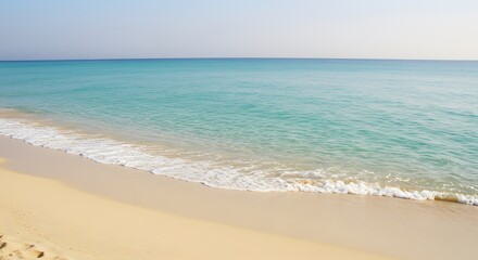 Fototapeta premium Gentle Waves Lapping on a Sandy Beach with Turquoise Ocean Water