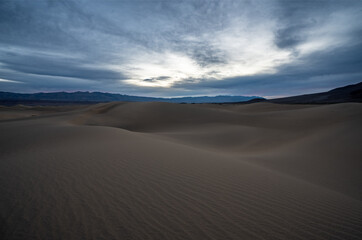 Sunrise over sand dunes in the Sahara Desert with a scenic, dry landscape and golden sands