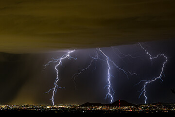 Tucson Arizona's Monsoon seasonal thunder and lightning storms over the downtown and A mountain...