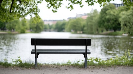 Fototapeta premium Park bench by a tranquil lake. Peaceful scene. Possible use Background for relaxation, meditation, or contemplation