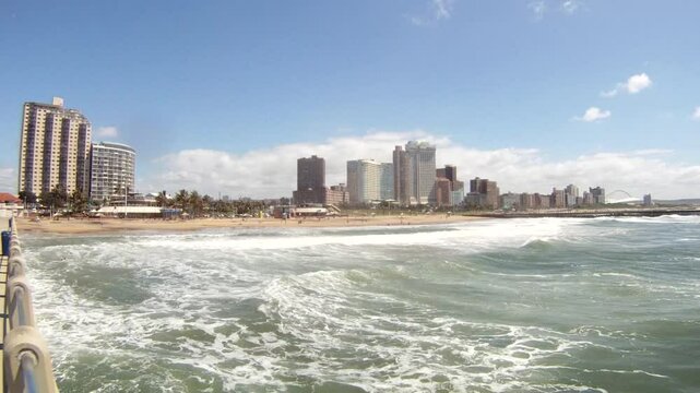 Panorama photo of Durban beachfront or cityscape. View from the main pier towards the big city skyscrapers on a sunny day.