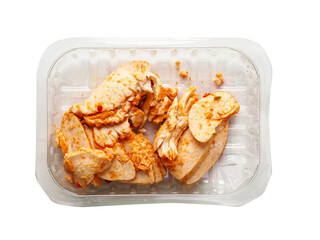 A tray of Cajun style chicken is on a white background. The chicken is cut into pieces. Small portion of poultry meat, ready to be eat or used for a sandwich.