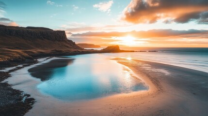 Fototapeta premium A beach shoreline curving around a bay with bright, shallow waters.