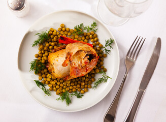 Delicious baked quail with canned green peas, baked carrot slices and fresh greens. Healthy delicious dinner.