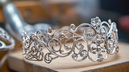 Obraz premium Handcrafted silver bracelet in progress with delicate filigree patterns.