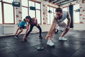 Crossfit Athletes Touching Barbell Weight In Gym.