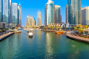 Obraz premium The Dubai Marina, a waterfront promenade of shops, boat marinas and skyscrapers, along the coast of Dubai, United Arab Emirates along the Persian Gulf.