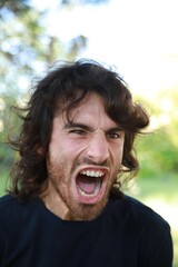 Angry Man Snorts Furiously In Nature Outside