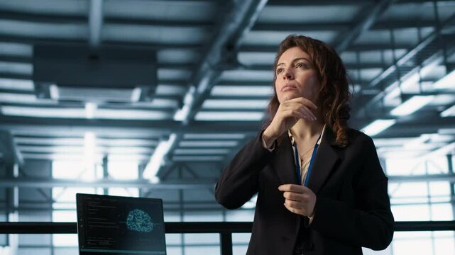 Technicians in high tech AI data center workspace looking at hologram visualization. Programmer working on securing server room hardware using AR artificial intelligence tech, camera A