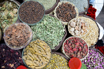 Curry in root and various spices displayed in a local bazaar market in Marrakesh