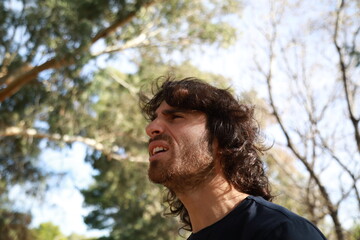 Long Hair Man Astonished To Read An Incomprehensible Poster On The Street
