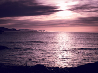 Obraz premium Pink sky with mountains and mist with godrays