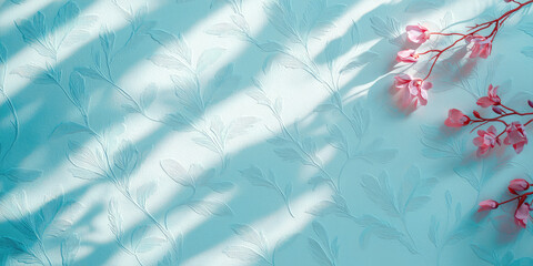 Obraz premium Wall with embossed floral ornament wallpaper in sunlight shadows. Abstract background for banner or web.
