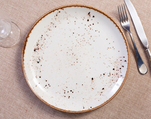 Empty plate and cutlery. Top view. Dining table in restaurant