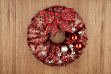 Winter Christmas wreath on the door with twinkling lights.