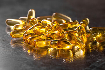 Capsule of omega 3, 6, 9 fish oil, vitamin isolated on black background. 